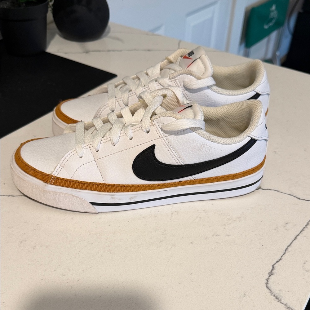 Nike White Sneakers with Black Swoosh and Gold Trim